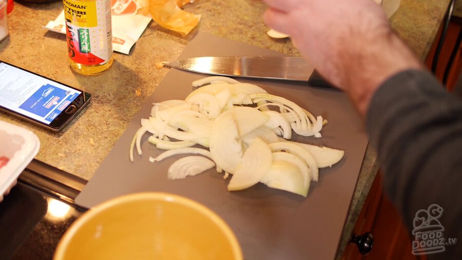 Onion is sliced on cutting board