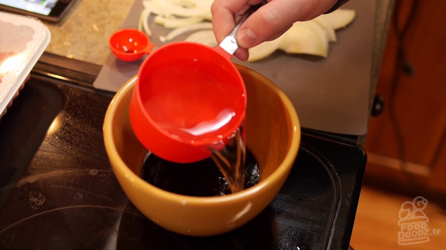 water is added to bowl with dashi powder, sake, mirin, and soy sauce