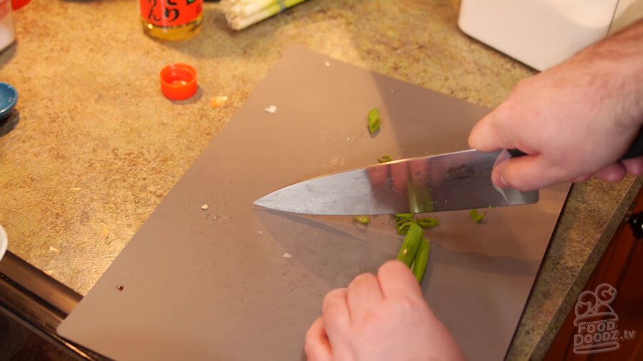 green onion is sliced on cutting board