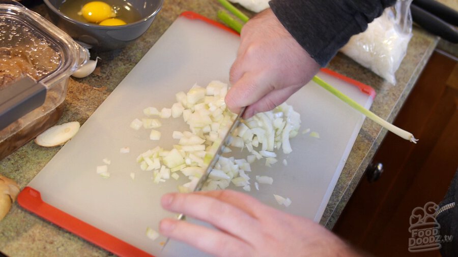 Onion is chopped on cutting board