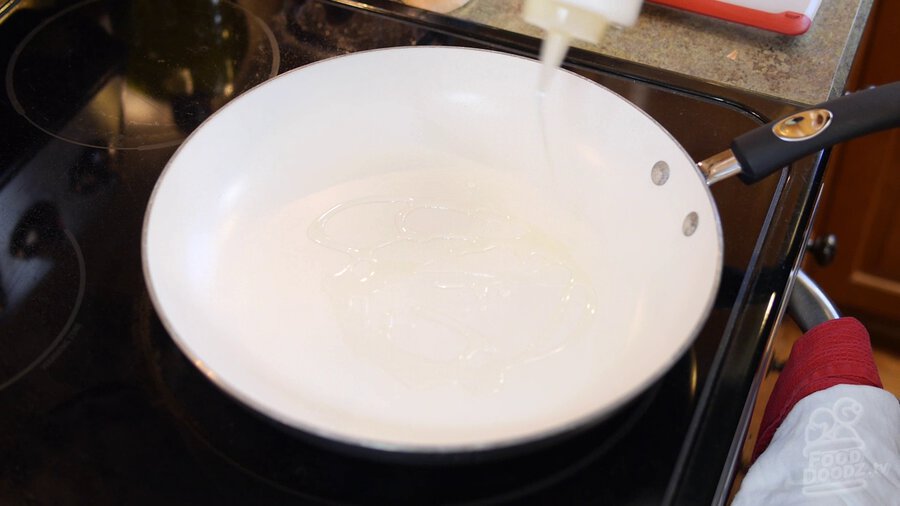 Vegetable oil is added to non-stick skillet