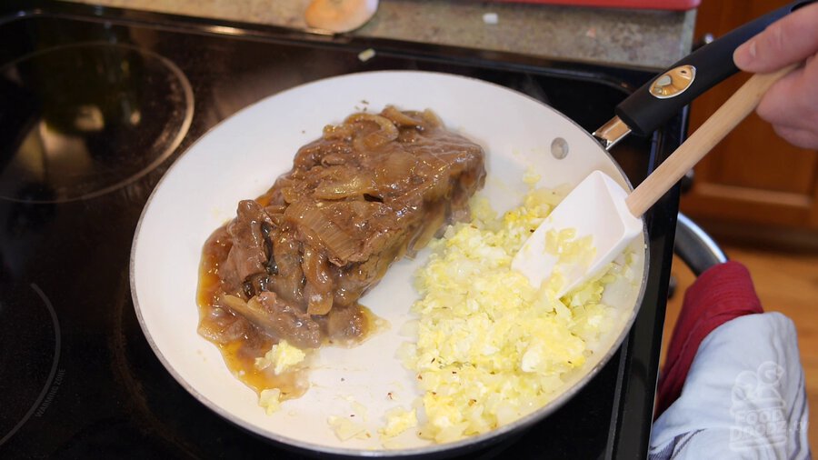 Leftover gyudonburl (beef rice bowl) beef is added to one side of pan while onion and eggs continue to cook on other