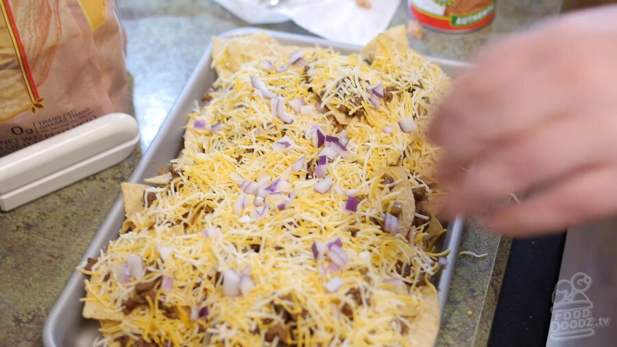 Another layer of cheese is added along with fresh chopped red onion