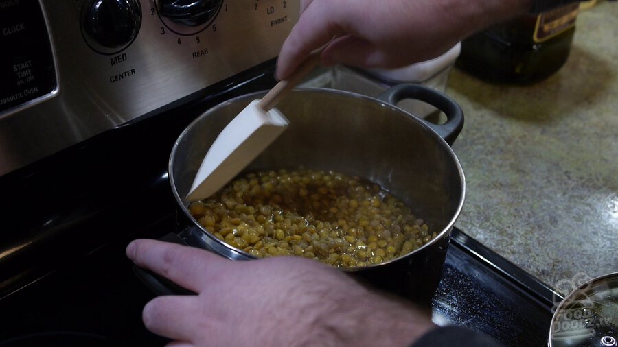 Spatula is used to stir lentils while the rehydrate in pot