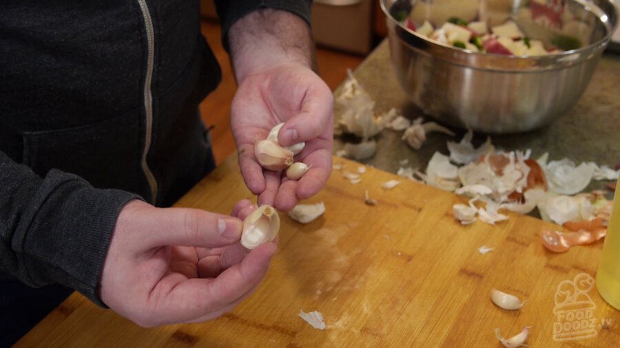 Cloves of garlic with paper still on broken off head of garlic