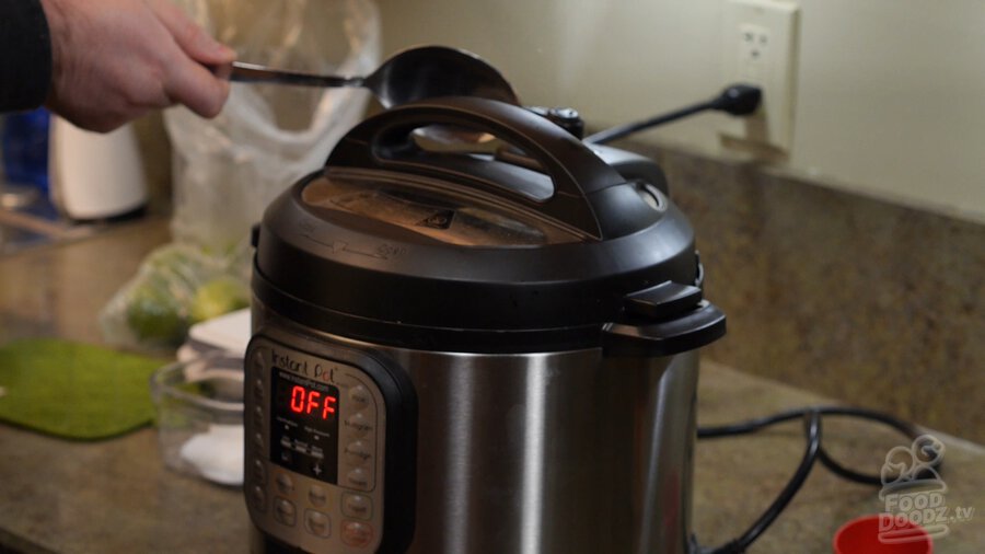 Using large spoon to release pressure valve on Instant Pot