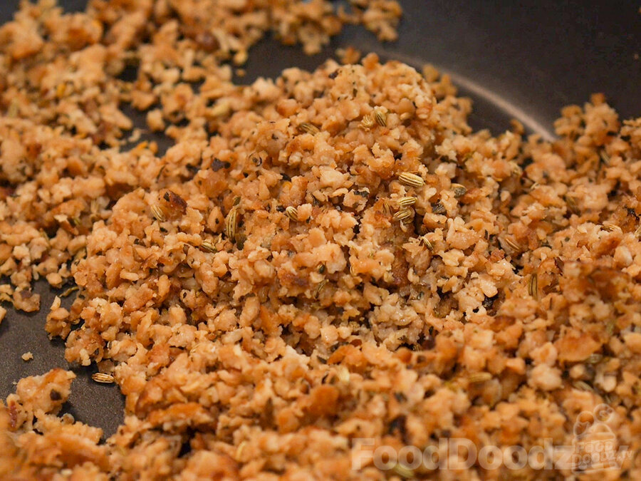 Pan full of delicious golden brown textured vegetable protein (TVP) Italian sausage flavored with fennel
