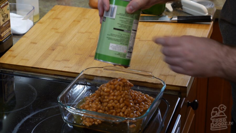 A can of baked beans poured into a baking dish