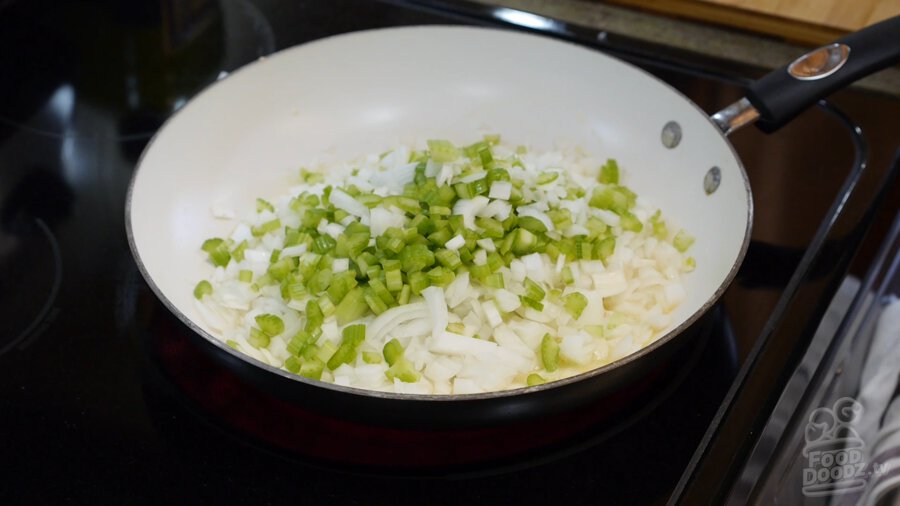 Onions and bell peppers sauting in a pan