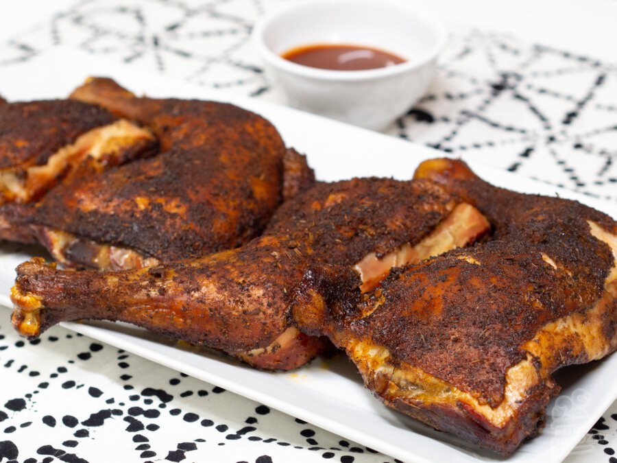 A plate of smoked barbecue chicken quarters is surely making your mouth water.