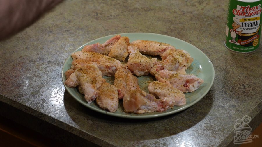 A plate of well seasoned raw chicken wings