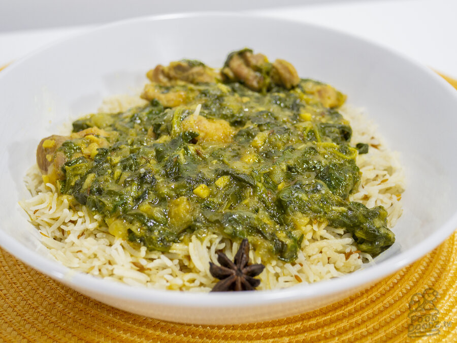 A delicious bowl of Indian Chicken Saag over cumin rice.