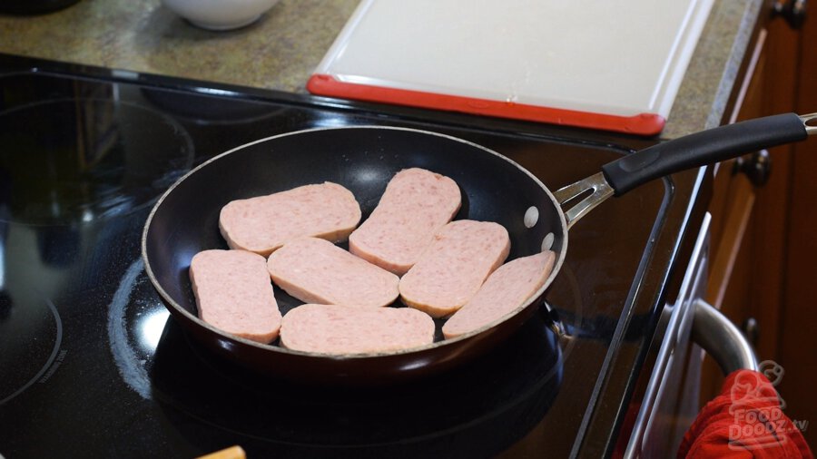 Spam slices added to pan