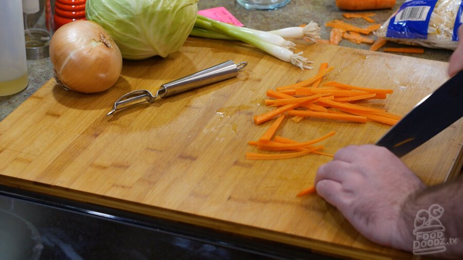 Thinly slicing carrots into matchsticks