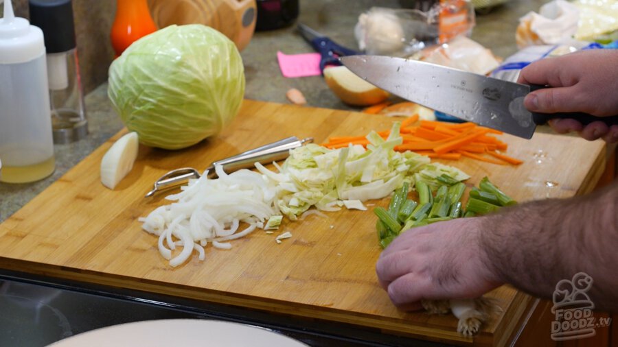 cutting green onion tops into 1 to 2 inch pieces