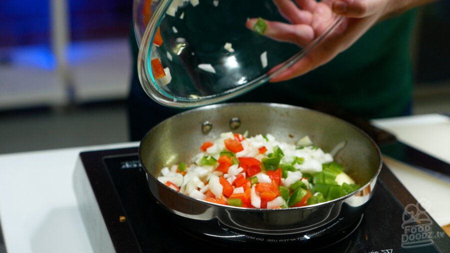 Addomg veggies to pan