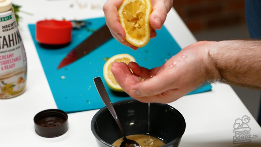 Squeezing lemon juice into the bowl