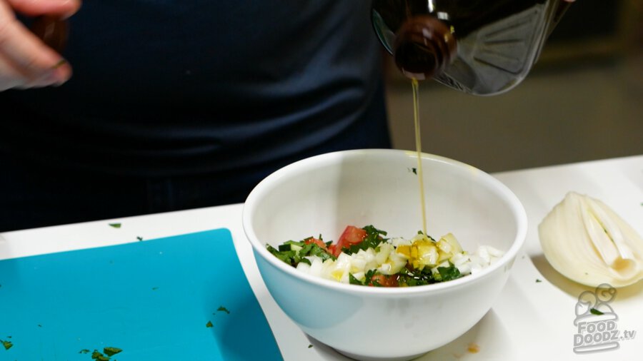 Drizzling olive oil into salad