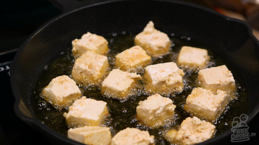 Tofu frying in pan