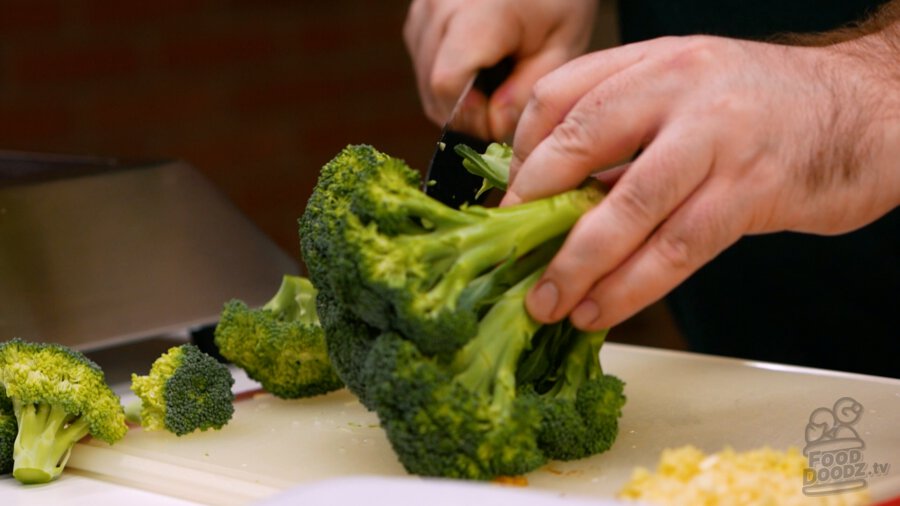 Slicing broccoli florets off the crown