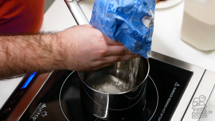 Adding flour to pan