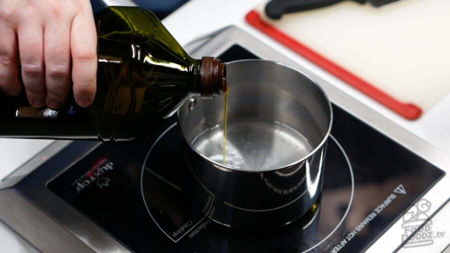 Adding olive oil to pot