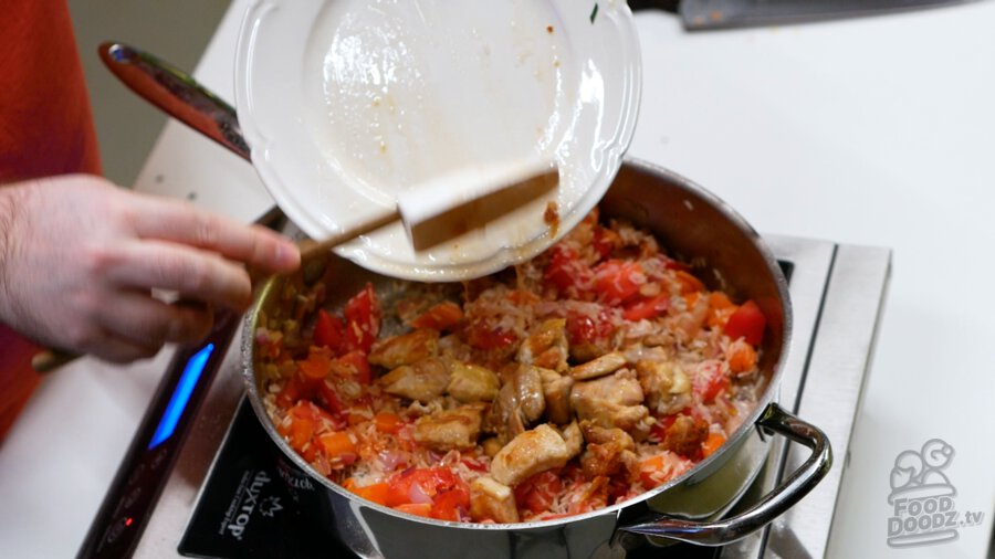 Adding the chicken pieces back along with their juices to the pan