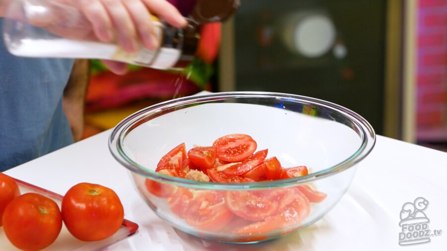 Sprinkling salt over tomatoes