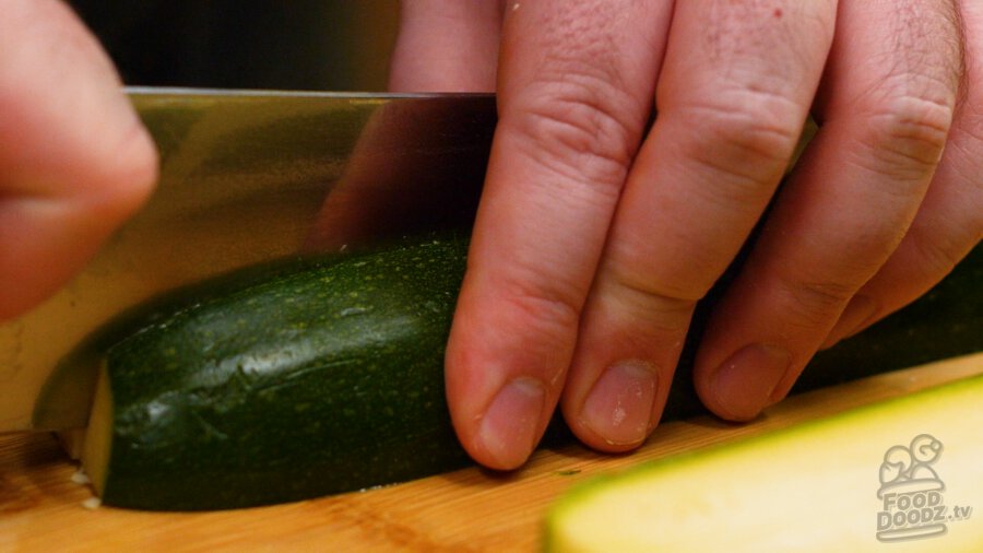 slicing zucchini half lengthwise