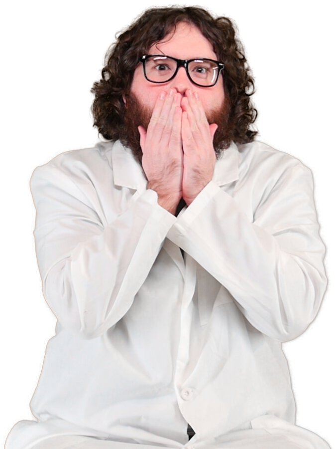 Adam lab coat with black glasses holding hands over mouth looking surprised