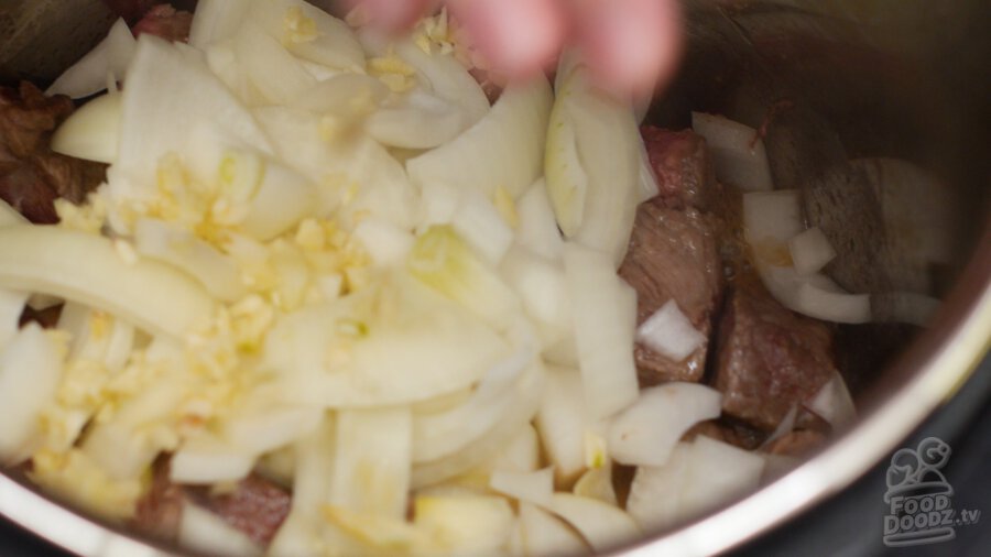 adding garlic to pressure cooker
