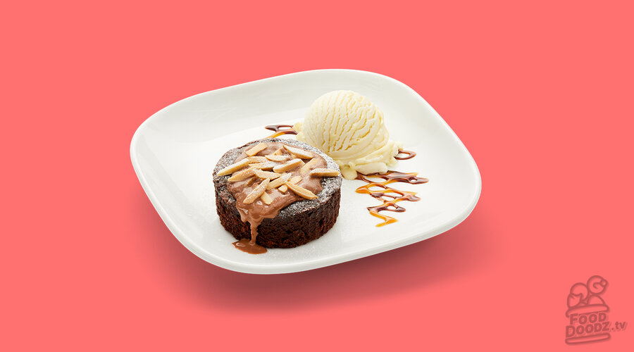Dark brown chocolate lava cake topped with toasted almonds, chocolate and caramel sauces from Boston Pizza. Served with vanilla ice cream