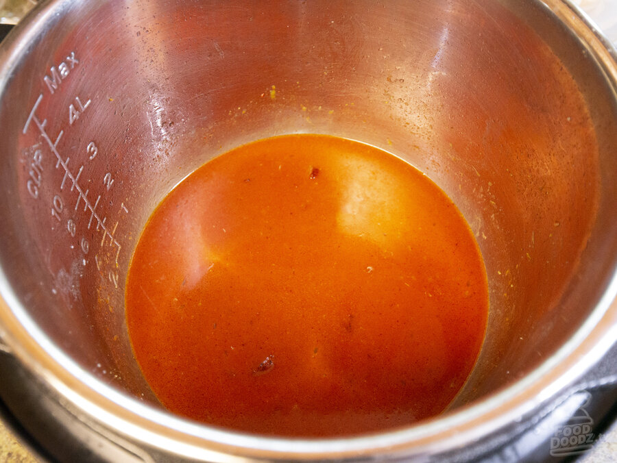 Orange juice, lime juice, and achiote paste dissolved in pan