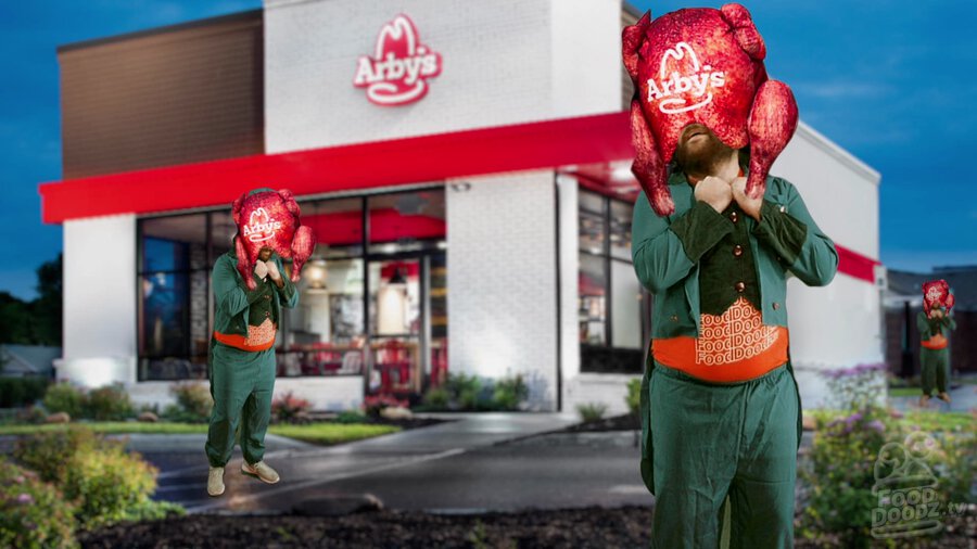 Adam dressed as leprechaun standing in front of Arby's with the Arby's turkey pillow on his head. He looks so happy!