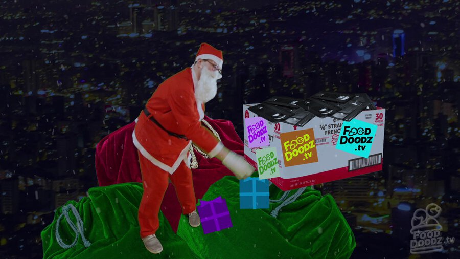 Austin dressed as Santa standing on top of sleigh throwing box of FoodDoodz.tv tapes off of sleigh