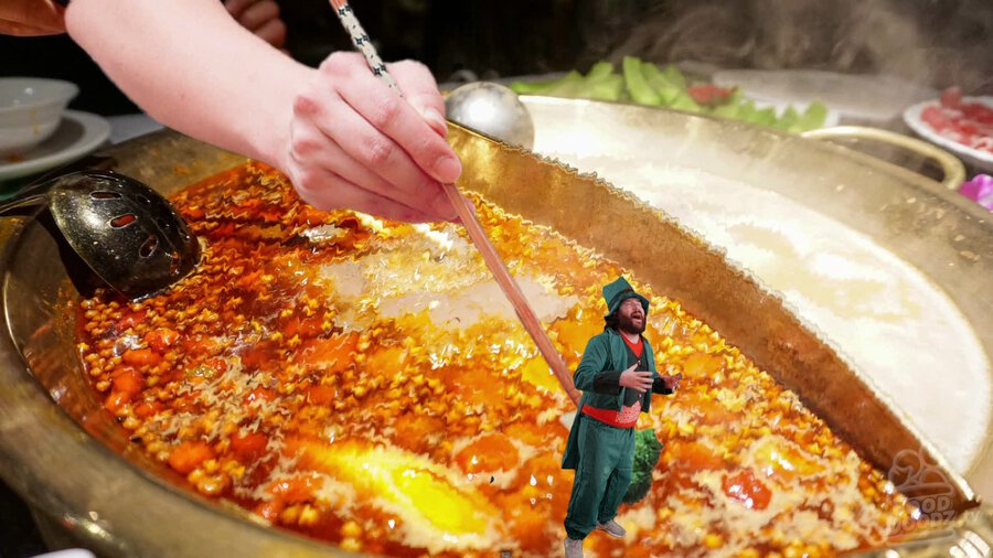 Adam dressed as leprechaun being lowered into a hot pot dish by a set of giant chopsticks and hand